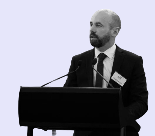 Mark Kirkpatrick speaking at a podium